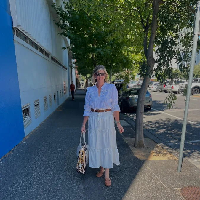 White blouse and tiered midi skirt stylish outfit for women over 50