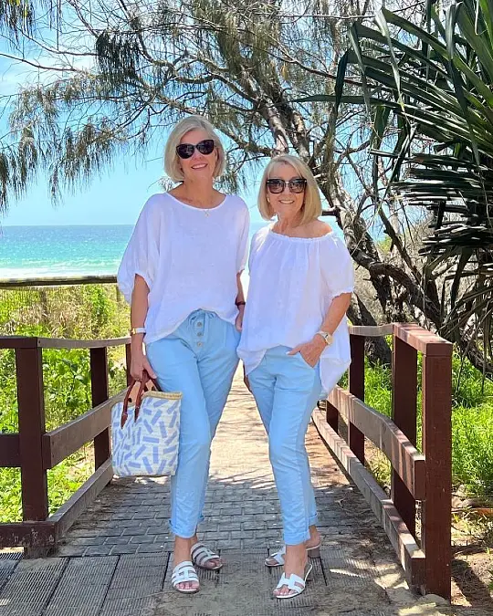 White tops with soft blue cropped pants cute outfits for women over 50