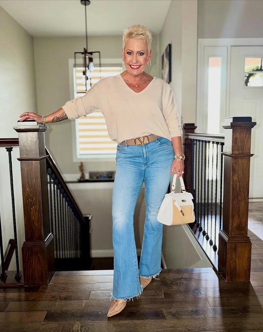 Cream sweater and flared jeans cute casual outfit for women over 50