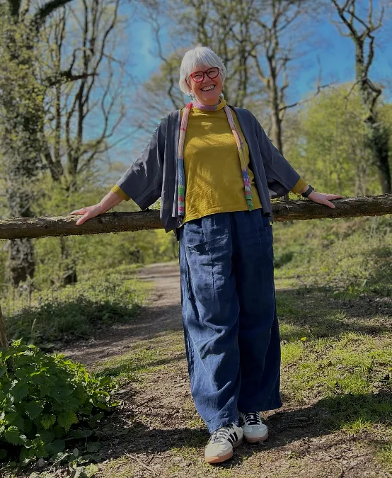 Mustard top with wide-leg navy pants hiking outfit for women over 50