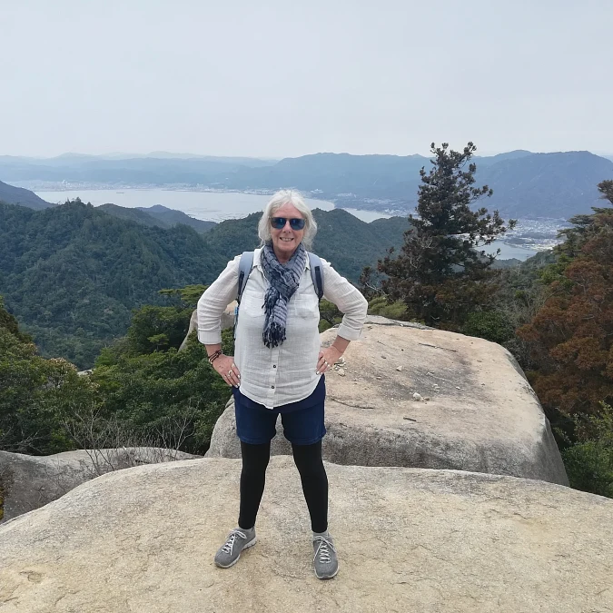 White hiking shirt with layered shorts and leggings for women over 50
