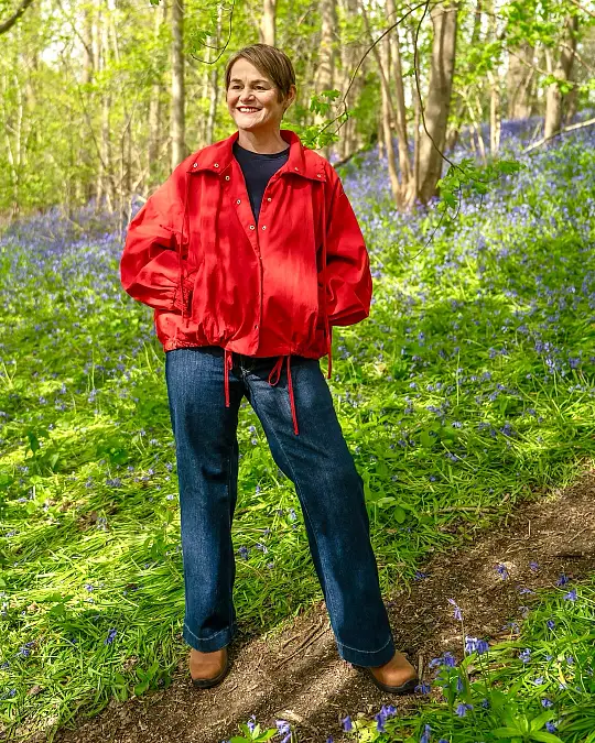 Red trail jacket and wide-leg jeans outdoor outfit for women over 50