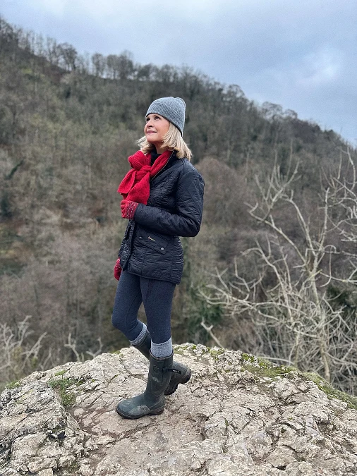 Quilted jacket leggings and tall boots hiking outfit for women over 50
