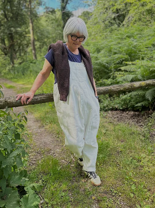 White overalls and lightweight knit hiking outfit for women over 50