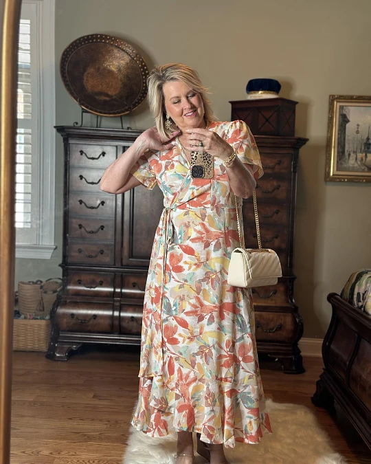 Floral wrap dress with neutral handbag outfit for women over 50