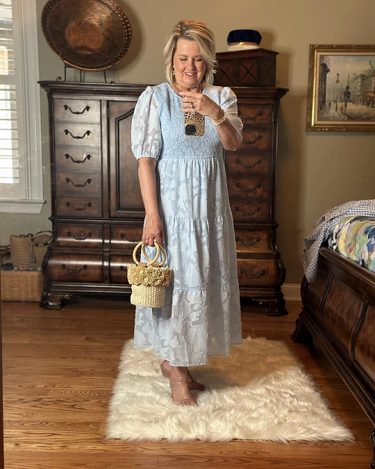 Light blue smocked midi dress with straw bag outfit for women over 50