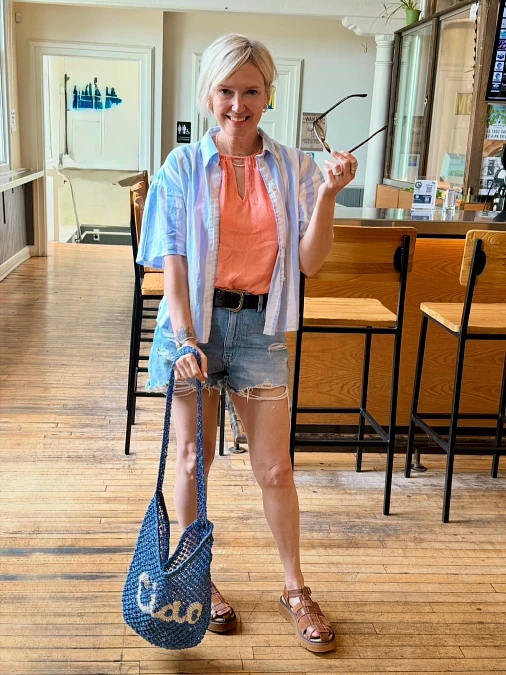 Striped shirt coral top and denim shorts simple outfit for women over 50