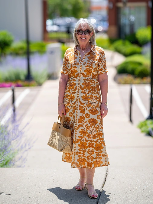 Orange floral midi dress with neutral accessories simple outfit for women over 50