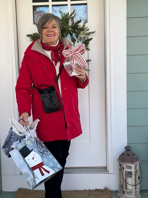 Red coat and white sweater Christmas outfit for women over 50
