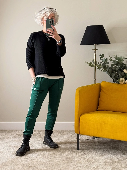 Black sweater and green track pants fall outfit