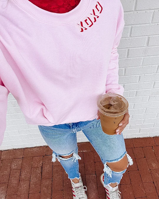 Pink sweatshirt and jeans casual Valentine’s Day outfit for women over 50