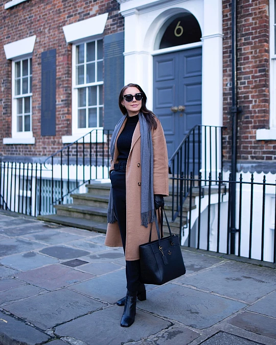 Camel coat and black knit winter work outfit for women over 50