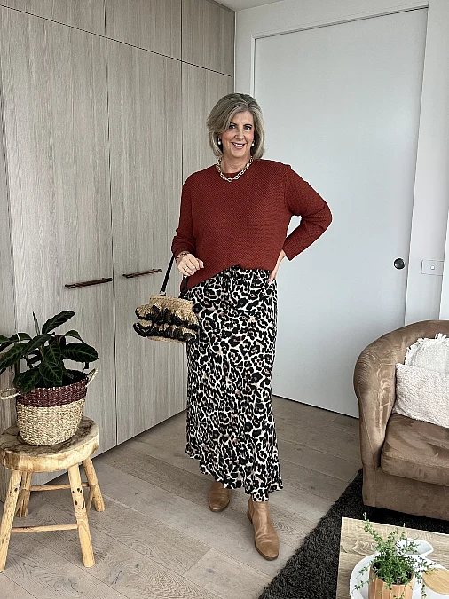 Rust sweater and leopard midi skirt winter work outfit for women over 50