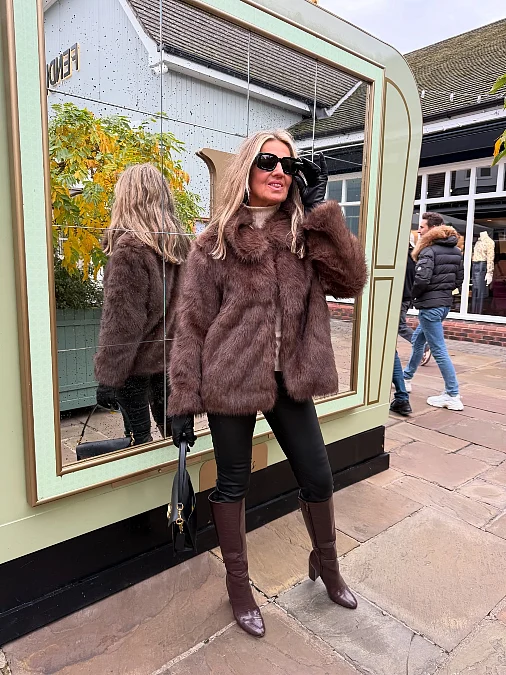 Chocolate faux fur jacket and tall boots winter work outfit for women over 50