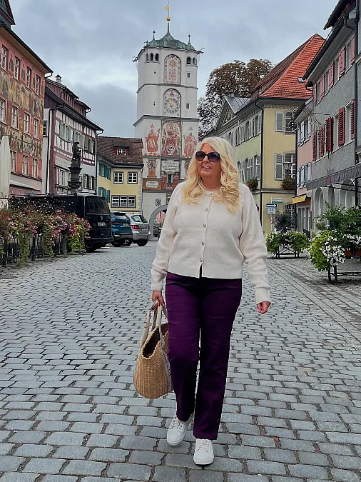 Cream cardigan and plum trousers winter work outfit for women over 50