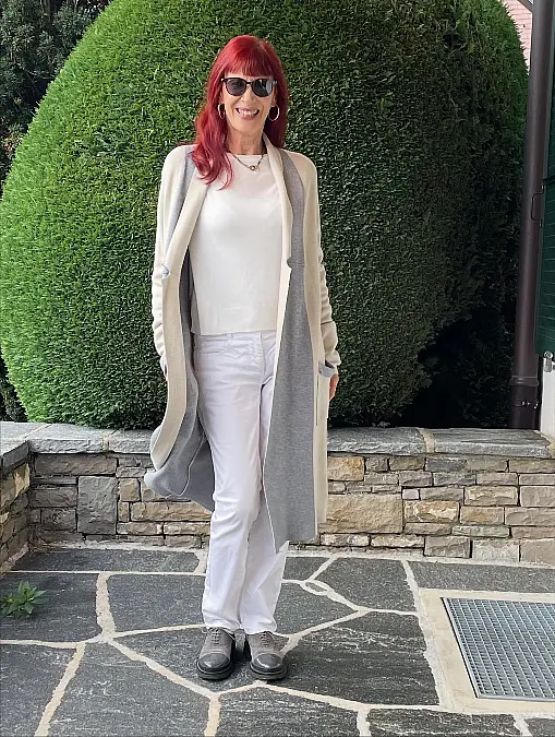 Soft cream layers and white trousers fall outfit for women over 50