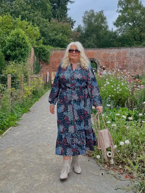Dark floral dress and fringe boots autumn outfit for women over 50